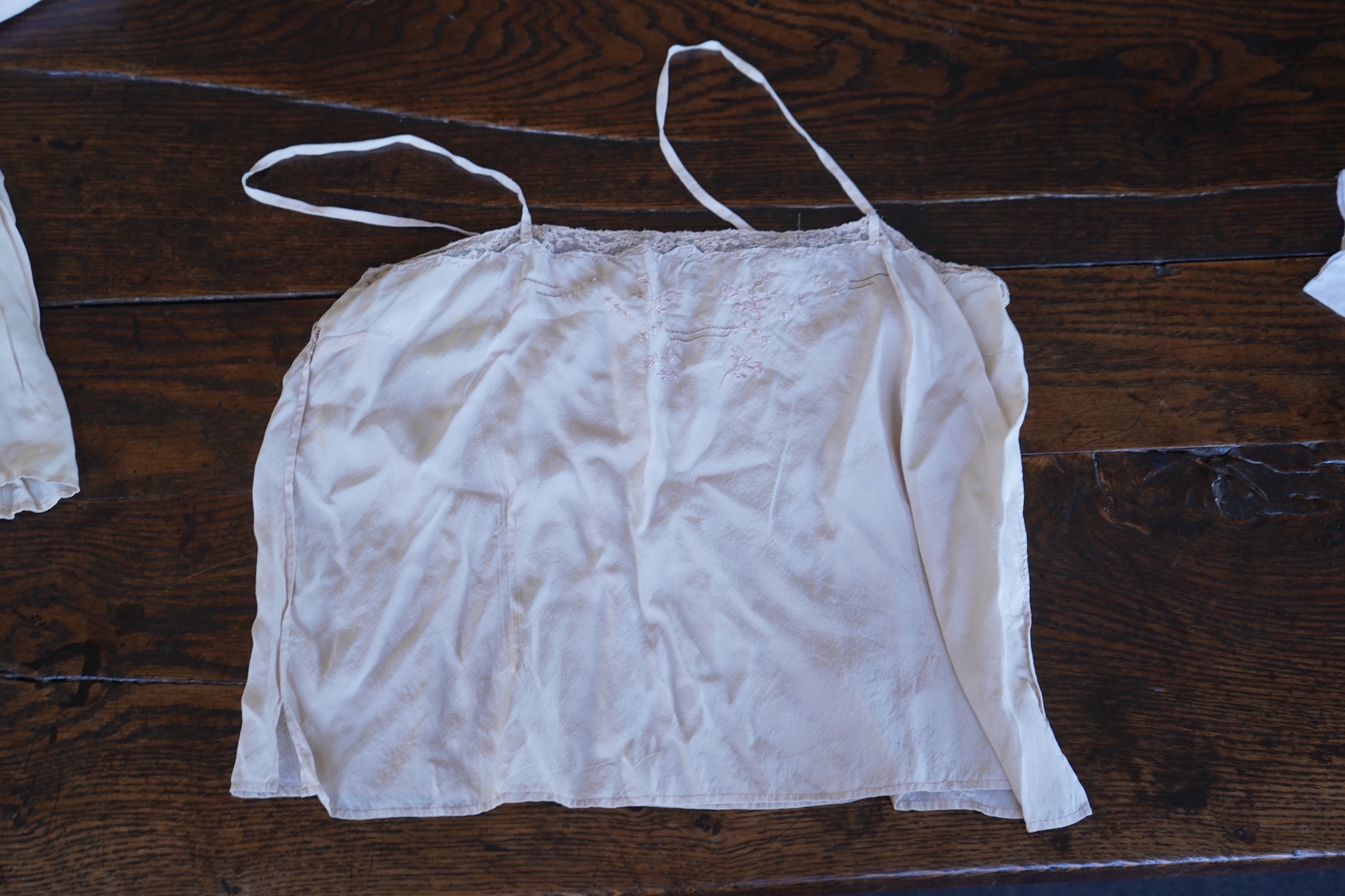 A collection of 1920's-30's silk and satin camisole slips, two cream silk and lace jackets, a lace blouse a silk embroidered blouse, a silk cami, and a collection of silk stockings., Condition- good